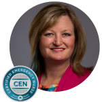 Headshot of BCEN CEO Janie Schumaker with the Certified Emergency Nurse (CEN) pin.