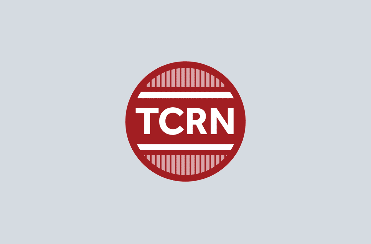 A red circular logo with the white letters "TCRN" in the center, set against a light gray background and bordered by horizontal red stripes.