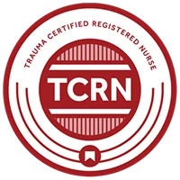 Red and white circular badge with the text "TRAUMA CERTIFIED REGISTERED NURSE" around the edge and "TCRN" in bold letters in the center.